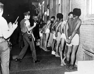 Members of the Black Panther Party, stripped, handcuffed, and arrested after Philadelphia police raided the Panther headquarters, August, 1970. Credit - Urban Archives, Temple University